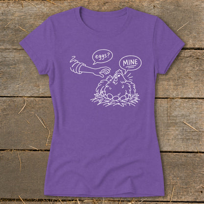 Purple t-shirt with graphic of a hen protecting eggs from a hand labeled "eggs?".