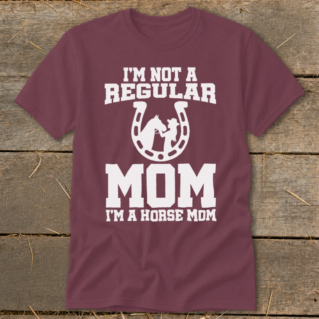 Maroon t-shirt with white text "I'M NOT A REGULAR MOM I'M A HORSE MOM" and horseshoe graphic.