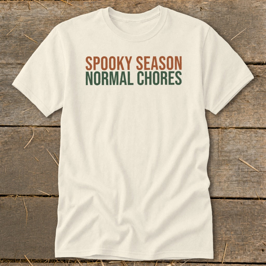 Cream t-shirt with "Spooky Season Normal Chores" text in brown and green.