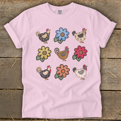 Pink t-shirt with watercolor-style chickens and flowers arrangement.