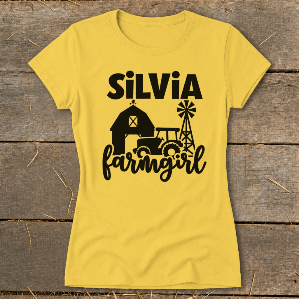 Yellow t-shirt with black text and graphics: "SILVIA farmgirl", barn, tractor, windmill.