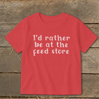Red t-shirt with white text "I'd rather be at the feed store".