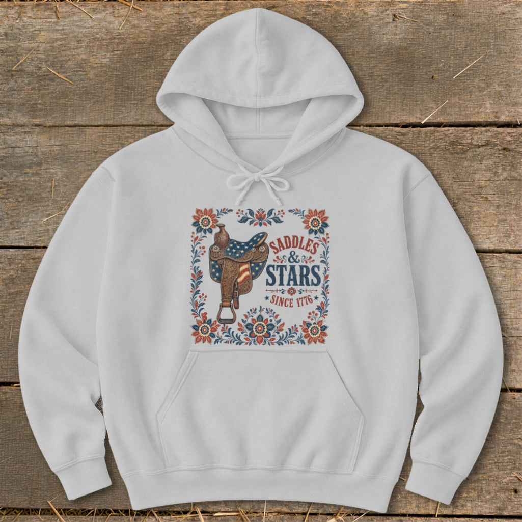White hoodie with a "Saddles & Stars Since 1776" graphic featuring a saddle.