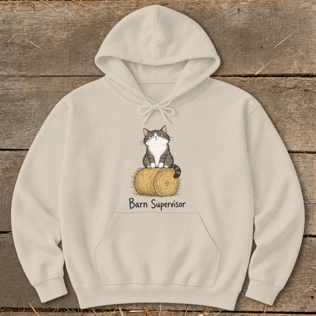 Light tan hoodie with a cartoon cat sitting on a hay bale, reading "Barn Supervisor".