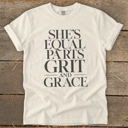 White t-shirt with "She's Equal Parts Grit And Grace" text in dark grey.