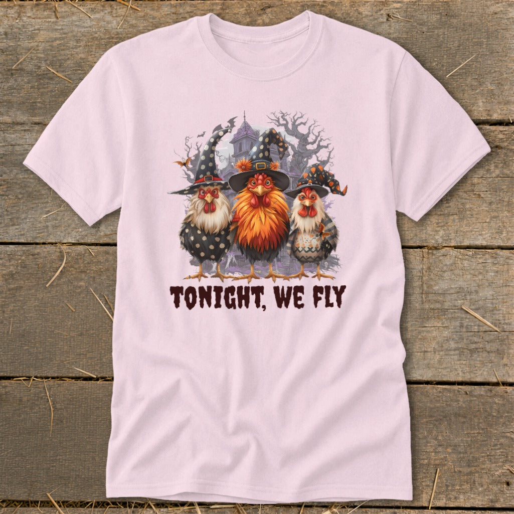 Three chickens wearing witch hats stand before a haunted house with text that reads "TONIGHT, WE FLY".
