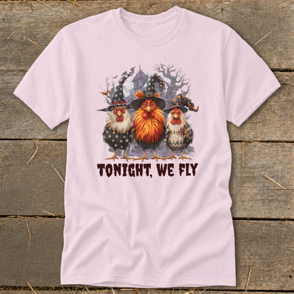 Three chickens wearing witch hats stand before a haunted house with text that reads "TONIGHT, WE FLY".