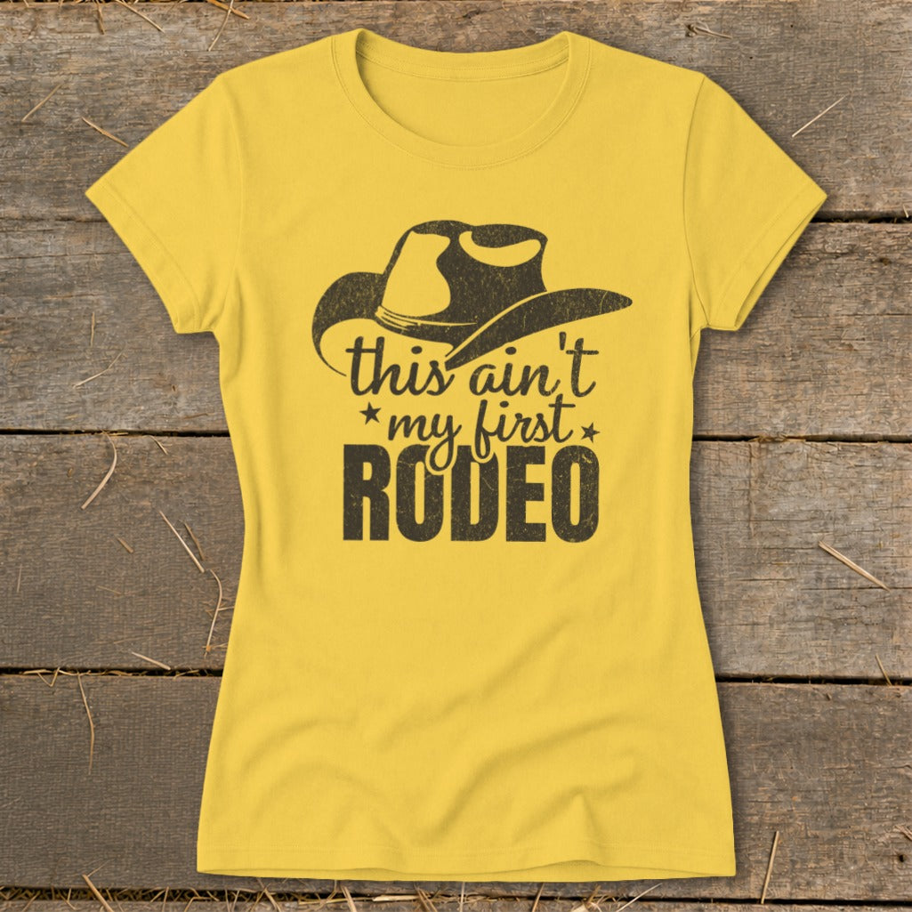 Yellow t-shirt with black cowboy hat graphic and "this ain't my first Rodeo" text.