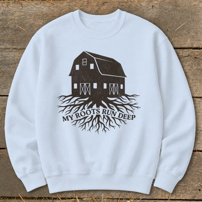 Light blue sweatshirt with dark brown barn and roots graphic and text.