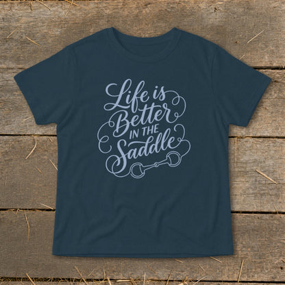 Navy t-shirt with "Life is Better IN THE Saddle" text and a horse bit graphic.