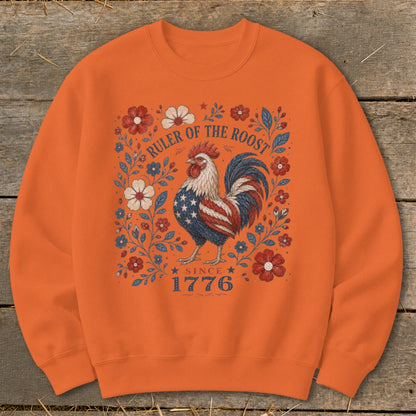 Orange sweatshirt with a patriotic rooster graphic and text "Ruler of the Roost Since 1776."