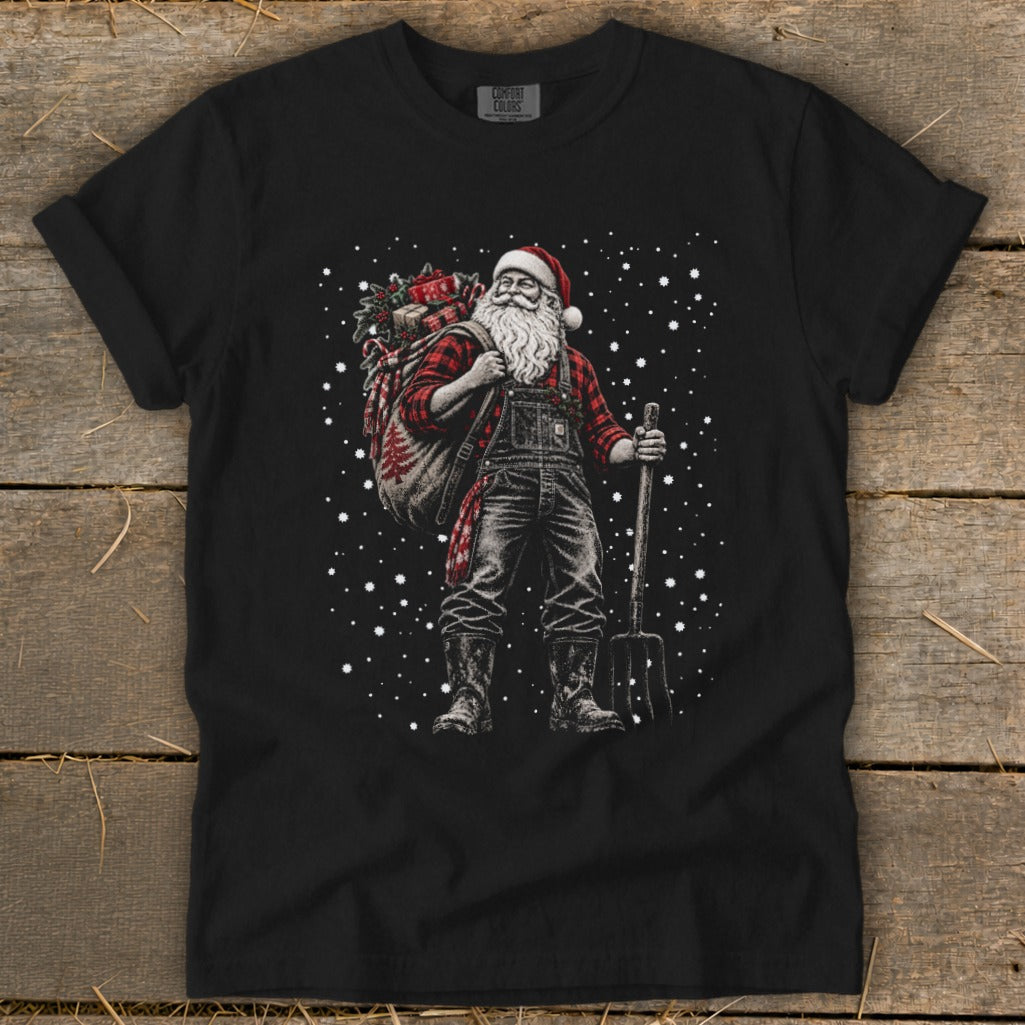 Santa Claus in overalls and plaid shirt carrying a sack and pitchfork amidst falling snow.