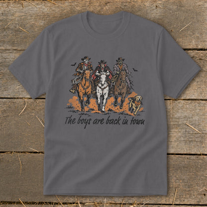 Skeleton cowboys and a vampire ride horses with a dog under the text "The boys are back in town."
