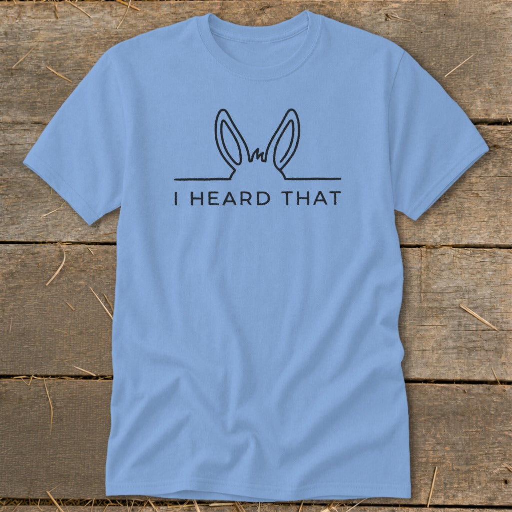 Light blue t-shirt with black line drawing of donkey ears and text "I HEARD THAT".