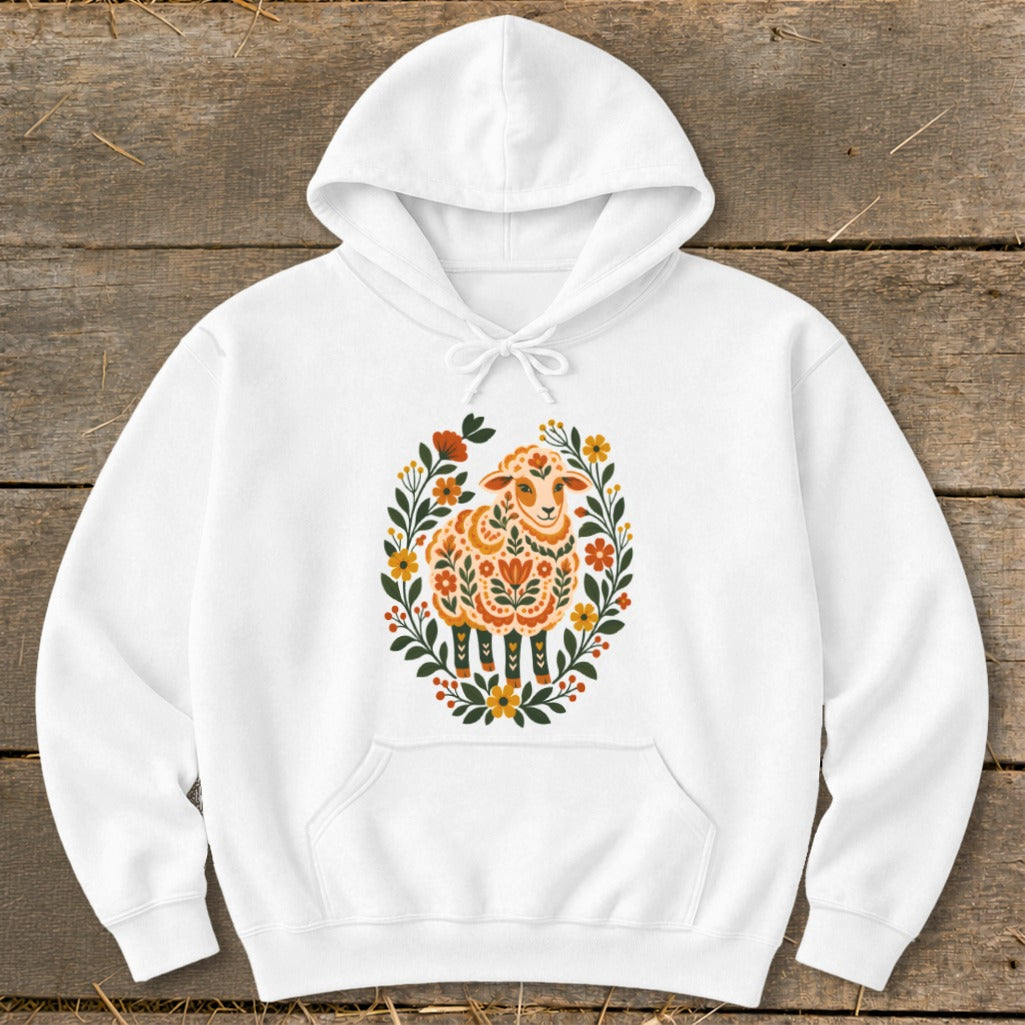 White hoodie with a central folk art sheep design surrounded by flowers.