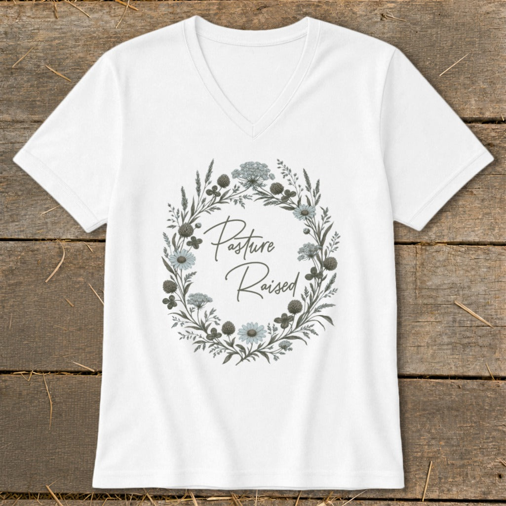 White v-neck t-shirt with floral wreath and "Pasture Raised" text.