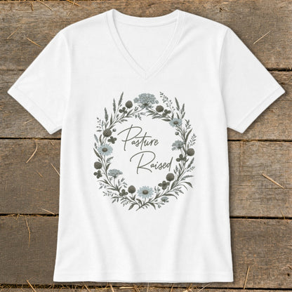White v-neck t-shirt with floral wreath and "Pasture Raised" text.