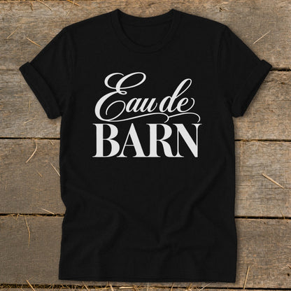 Black t-shirt with white text "Eau de BARN" in decorative font.