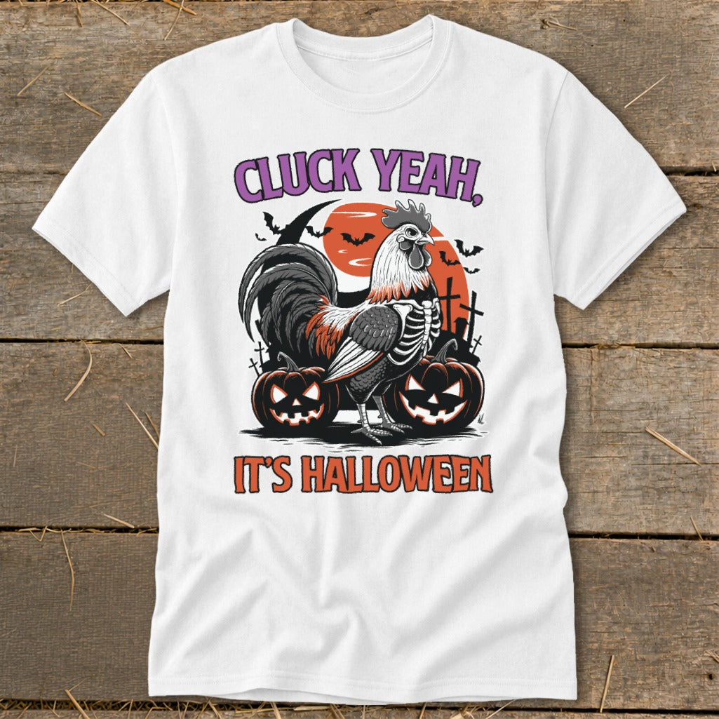 White t-shirt with skeleton rooster, pumpkins, and "Cluck Yeah, It's Halloween" text.