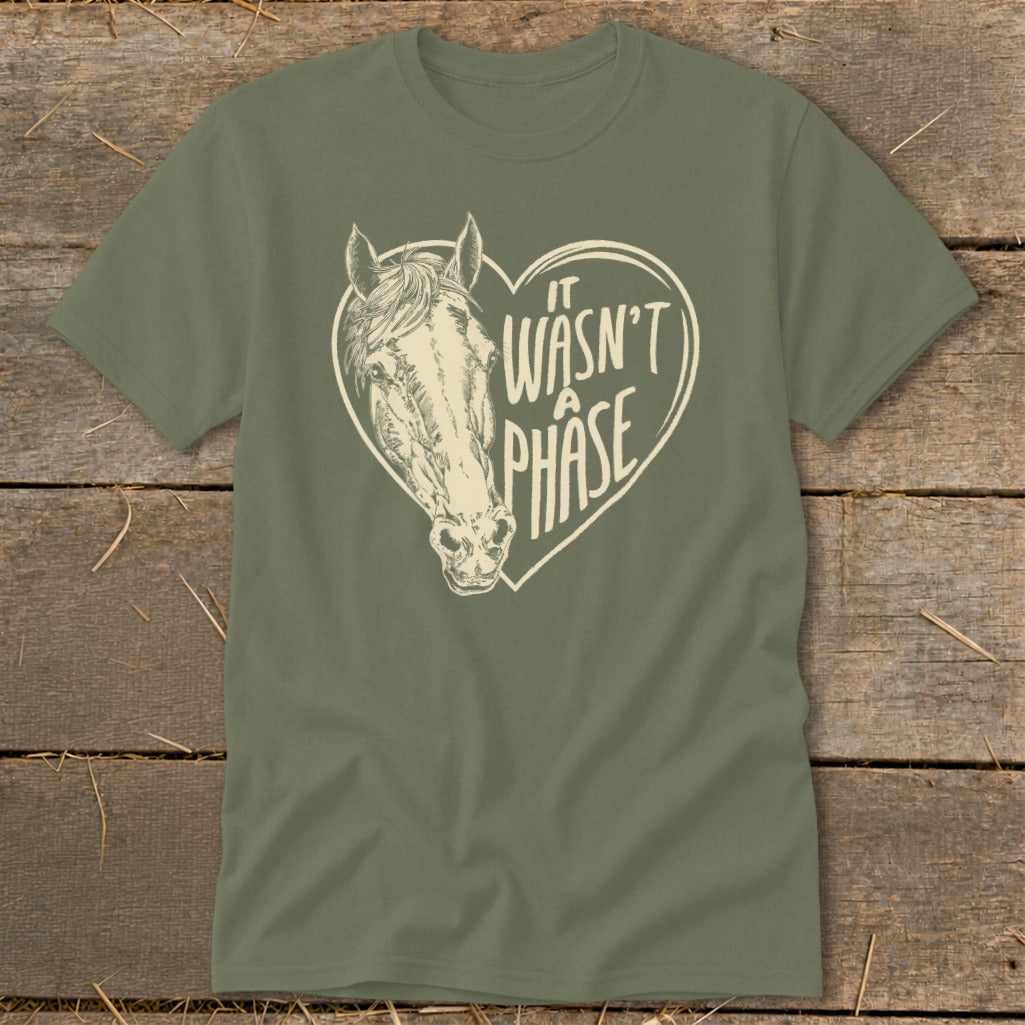 Olive green t-shirt with a horse head inside a heart that says "It Wasn't A Phase."