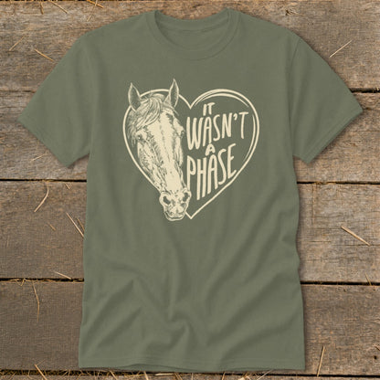 Olive green t-shirt with a horse head inside a heart that says "It Wasn't A Phase."