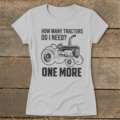 Light grey t-shirt with a tractor graphic and text "HOW MANY TRACTORS DO I NEED? ONE MORE".