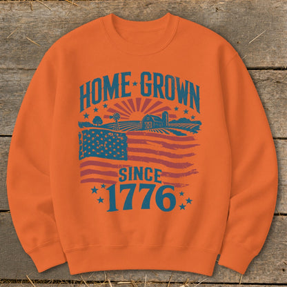 Orange sweatshirt with "HOME GROWN SINCE 1776" text and farm landscape with flag.