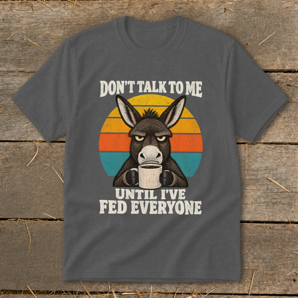 Charcoal t-shirt featuring a graphic of a grumpy donkey drinking coffee with sunset stripes and text.