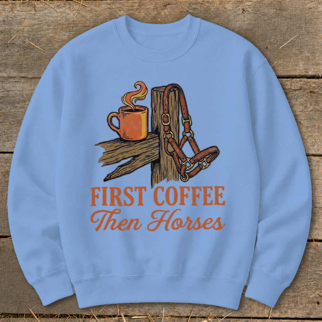 Light blue sweatshirt with "First Coffee Then Horses" graphic of a coffee cup and horse halter.