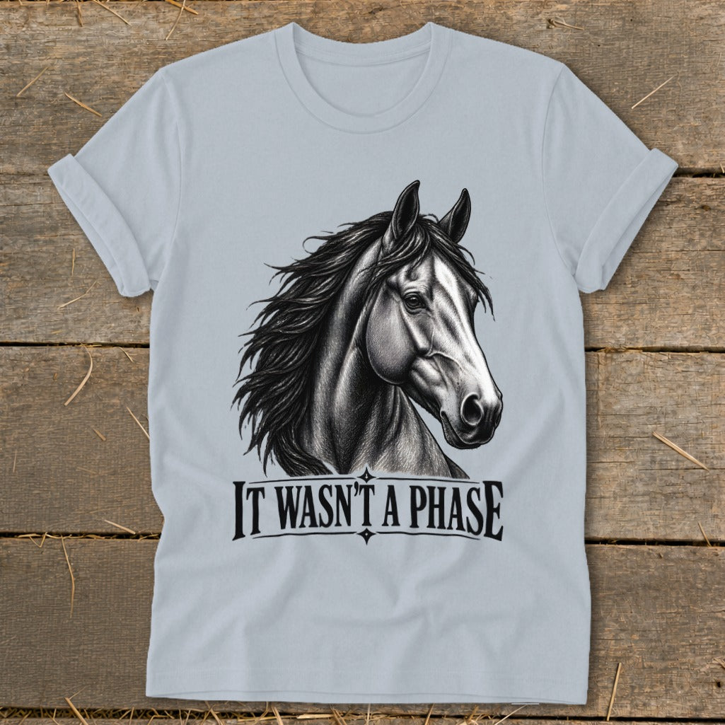 Light blue t-shirt with black drawing of a horse head and "IT WASN'T A PHASE".
