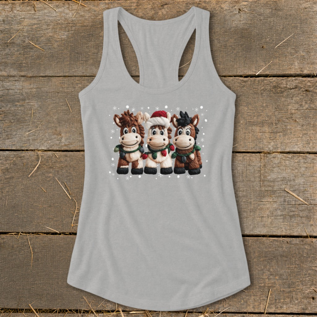 Three cartoon horses wearing Christmas scarves and lights on a grey tank top.