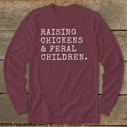 Maroon long-sleeve shirt with white text "RAISING CHICKENS & FERAL CHILDREN."