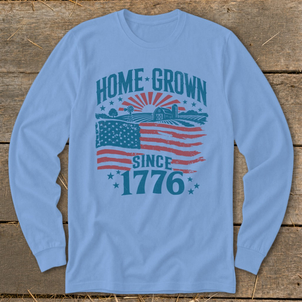 Long-sleeve shirt with "HOME GROWN SINCE 1776" graphic featuring American flag and farm scene.