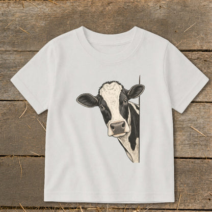 White t-shirt with a black and white cow peeking from the side.