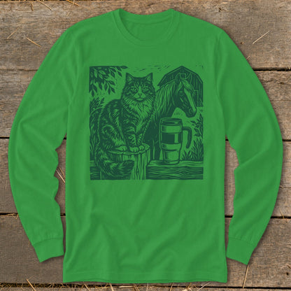 Green long-sleeve shirt featuring a woodcut illustration of a cat, horse, mug, and barn.
