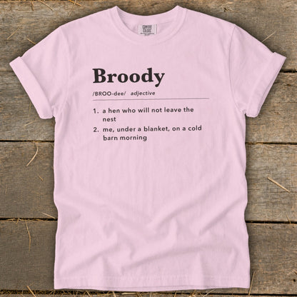 Pink t-shirt with "Broody" definition: "a hen who will not leave the nest" and "me, under a blanket, on a cold barn morning".