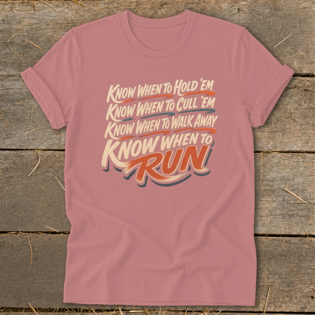 Pink t-shirt with text: "Know when to hold 'em, Know when to cull 'em, Know when to walk away, Know when to Run."