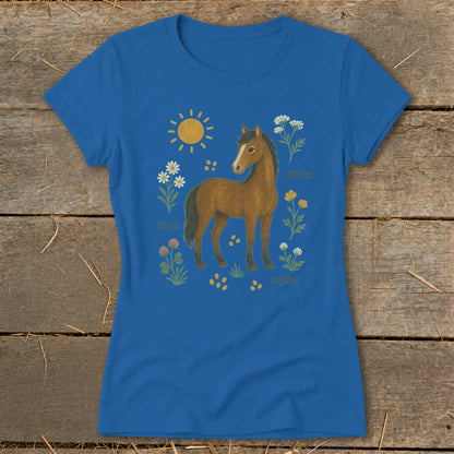 Blue t-shirt with a brown horse illustration surrounded by flowers and sun.
