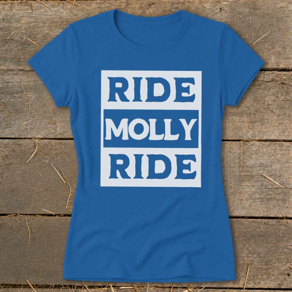 Blue women's t-shirt laid flat on a wooden background, featuring the white text RIDE MOLLY RIDE.