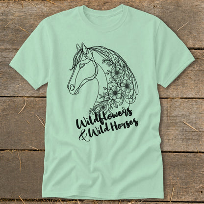 Pale green t-shirt with black line art of a horse head adorned with wildflowers and text.