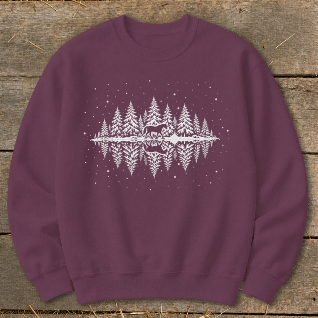 Maroon sweatshirt with white graphic of horse and reflection in winter forest scene.