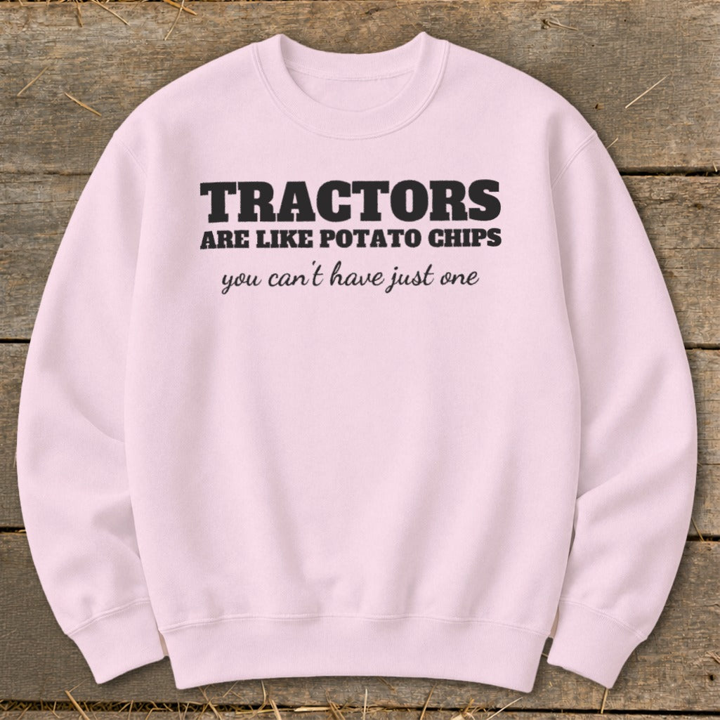 Light pink sweatshirt with black text reading "Tractors are like potato chips you can't have just one".