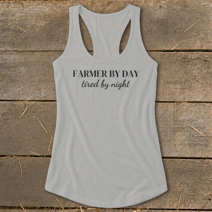Light grey racerback tank top with "FARMER BY DAY tired by night" text.