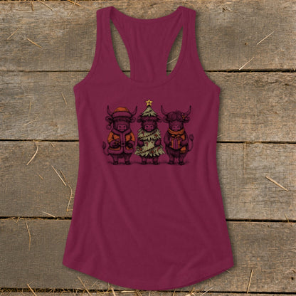 Three highland cows dressed for Christmas, one as a tree, on a maroon tank top.