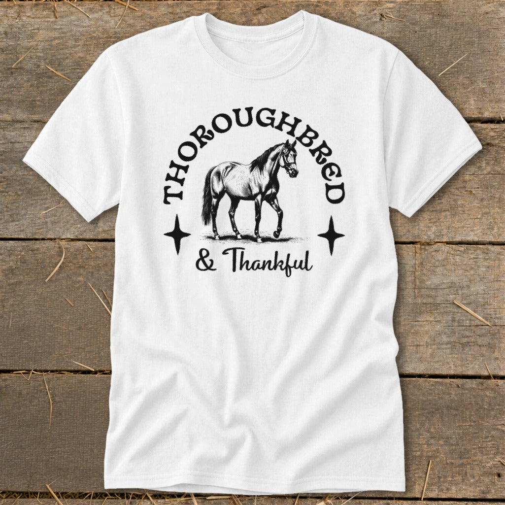 White t-shirt with a drawing of a horse and the text "THOROUGHBRED & Thankful".
