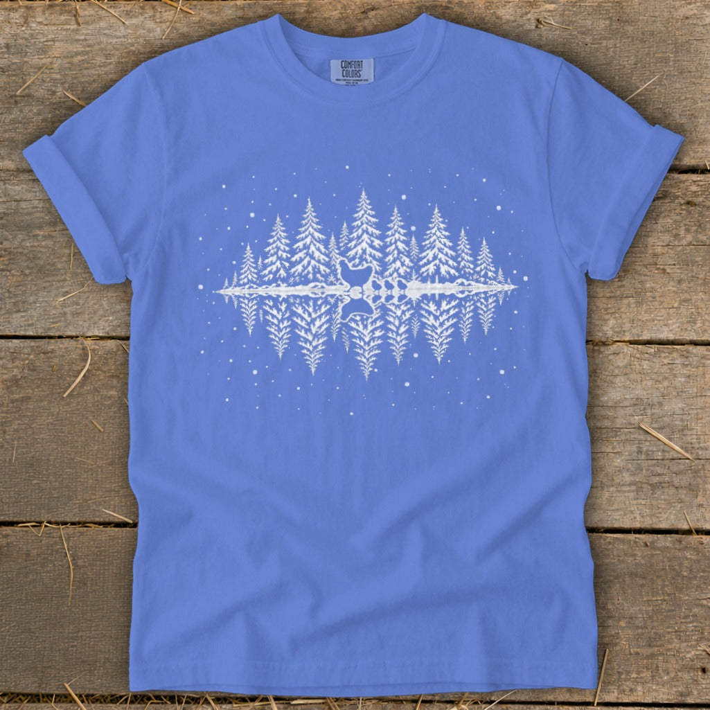 Blue t-shirt with white pine trees and a reflection of chickens in water.