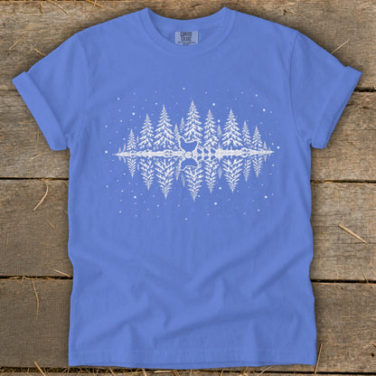 Blue t-shirt with white pine trees and a reflection of chickens in water.