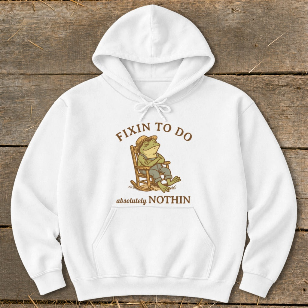 White hoodie with frog in rocking chair graphic: "Fixin to do absolutely nothin".
