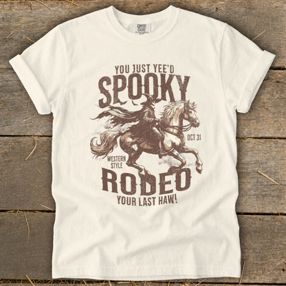 White t-shirt with graphic: "You just yee'd Spooky Rodeo Your Last Haw!" OCT 31.