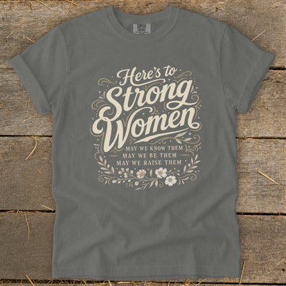 Graphic t-shirt with "Here's to Strong Women" text and floral accents.